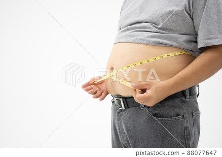 Overweight Man uses a measurement tape for measures his fat belly. isolated on white background. Concept of Healthcare, medicine, and  Weight loss 88077647