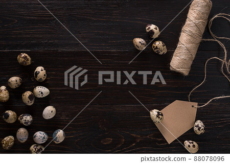 Quail eggs, place for text on dark wooden background top view Quail eggs, place for text on dark wooden background top view 88078096