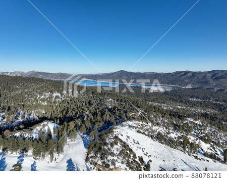 Aerial view over Big Bear Valey and Lake with now, South California, USA 88078121