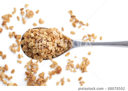 Heap of granola oats on a spoon selective focus Heap of granola oats on a spoon selective focus 88078502
