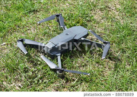 Mini drone unfolded on a grass before take-off. Mini drone unfolded on a grass before take-off. 88078889