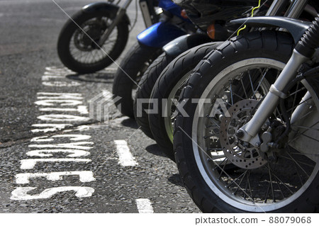 Front wheels of motorcycles parked in a bay Front wheels of motorcycles parked in a bay 88079068