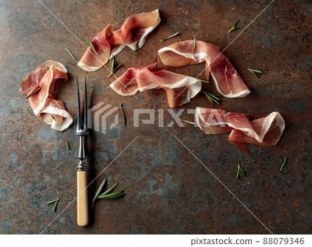 Prosciutto with rosemary on vintage background. 88079346