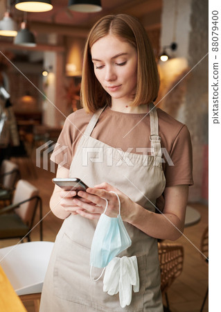Modern Caucasian woman working in cafe standing with mask put off surfing internet during break 88079400