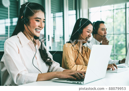 Business people wearing headset working actively in office Business people wearing headset working actively in office 88079953
