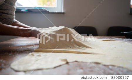 Stretching homemade pastry dough Stretching homemade pastry dough 88080567