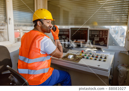 Young man working hard at heavy industry plant Young man working hard at heavy industry plant 88081027
