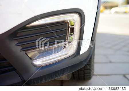 Broken headlight automobile close-up. Destroyed front light on the left side. Car crash or accident. Insurance, repair. Broken headlight automobile close-up. Destroyed front light on the left side. Car crash or accident. Insurance, repair. 88082485