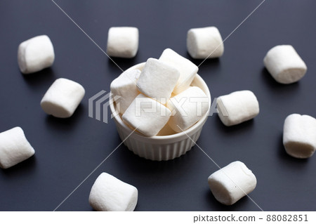 Delicious fluffy round marshmallows, White candy on dark background. Delicious fluffy round marshmallows, White candy on dark background. 88082851