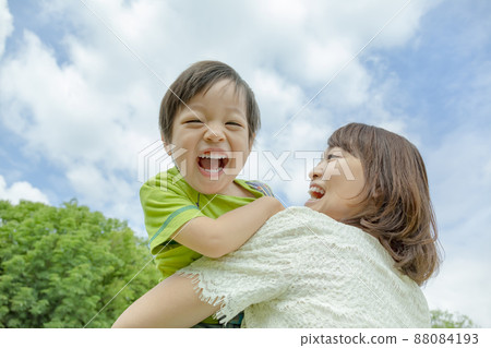 Son and mother playing in the park Son and mother playing in the park 88084193