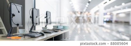 Call center computers and headsets all in office in widen view 88085604