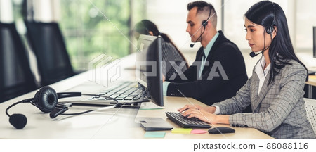 Business people wearing headset working in office broaden view Business people wearing headset working in office broaden view 88088116