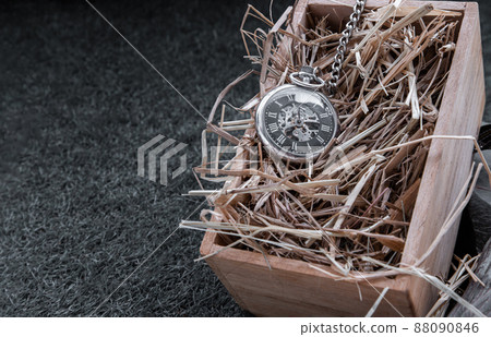 A retro pocket watch on straw background in wooden box. A retro pocket watch on straw background in wooden box. 88090846