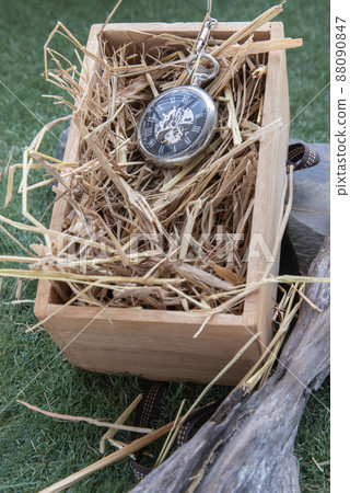A retro pocket watch on straw background in wooden box. 88090847