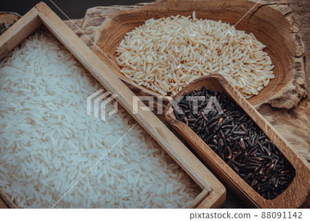 Various types of rice : Brown rice, Jasmine rice, Riceberry on old wooden background. Organic raw rice collection, Healthy food and diet concept, Overhead view, Selective focus. Various types of rice : Brown rice, Jasmine rice, Riceberry on old wooden background. Organic raw rice collection, Healthy food and diet concept, Overhead view, Selective focus. 88091142