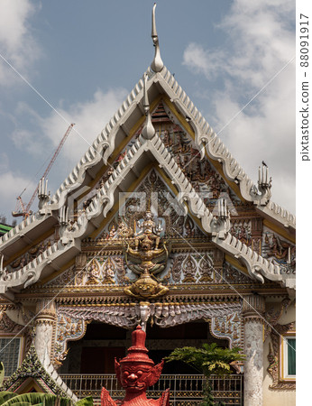 Stucco figure the red giant standing guardian at the entrance of the ordination hall in Wat khlong phum temple. Stucco figure the red giant standing guardian at the entrance of the ordination hall in Wat khlong phum temple. 88091917