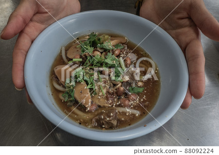 Hainan dry rice noodle with braised pork in Thai style on stainless steel table. Very delicious local food with many kinds of ingredients. Thai street food. Hainan dry rice noodle with braised pork in Thai style on stainless steel table. Very delicious local food with many kinds of ingredients. Thai street food. 88092224
