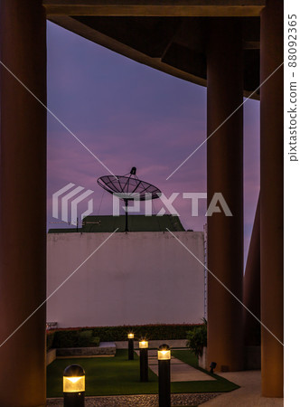 Black Satellite Dish Antenna Receiver Against on Blue Sky background. 88092365