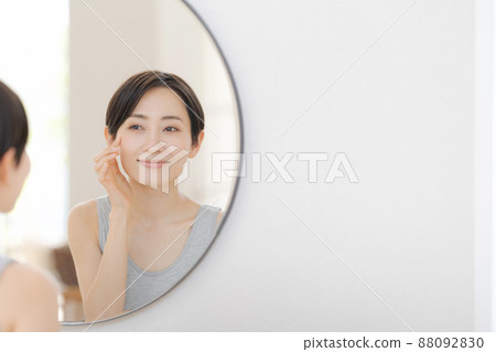 Woman looking in the mirror 88092830