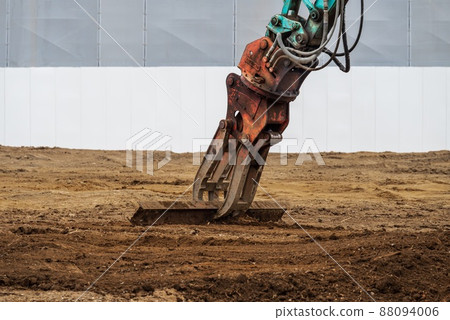 Heavy machinery leveling the ground after demolition work 88094006
