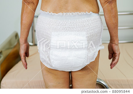 Asian senior woman patient wearing adult incontinence diaper pad in hospital. Asian senior woman patient wearing adult incontinence diaper pad in hospital. 88095844