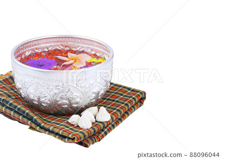 Bowl of water with colorful flowers for songkran festival on Thai traditional fabric isolated on white 88096044