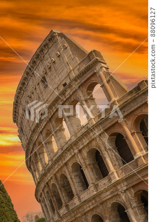 Colosseum at sunset with clouds and cypresses, Rome, Italy 88096127