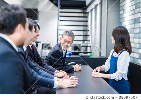 A businessman talking in the office cafeteria A businessman talking in the office cafeteria 88097507