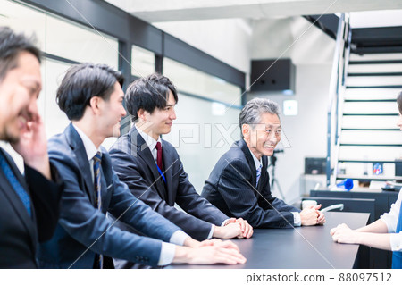 A businessman talking in the office cafeteria 88097512