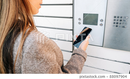 Postal terminal. Post delivery automat service and hands with parcel courier box. Mail delivery and post service concept. 88097904