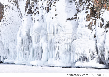Frozen splash water on Baikal lake. Abstract winter background. Amazing scenery with frozen water Frozen splash water on Baikal lake. Abstract winter background. Amazing scenery with frozen water 88098112