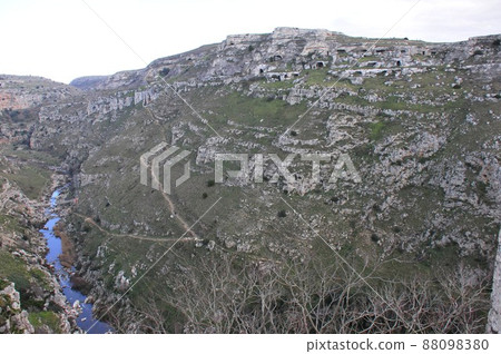Matera, Italy, Gravina River flowing under the cave dwelling "sash" 88098380
