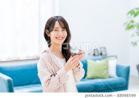 Young woman drinking mineral water Young woman drinking mineral water 88098599