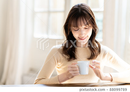 A woman relaxing with coffee A woman relaxing with coffee 88099789