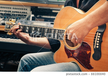 left-handed man playing guitar, close-up left-handed man playing guitar, close-up 88100840