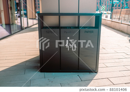 recycling and garbage concept. Modern trash container for metal, glass and plastic waste sorting on city street 88101406
