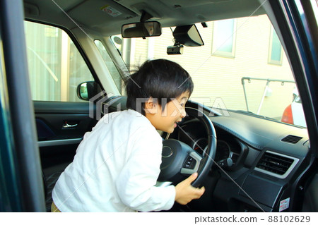Boy playing in a car, 5 years old Boy playing in a car, 5 years old 88102629