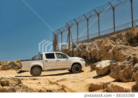 Military base with barbed wire fence. 88103380