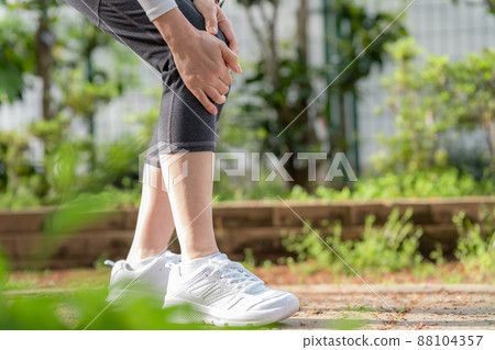 Woman suffering from knee pain, knee joint 88104357