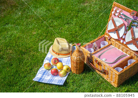Picnic basket on green sunny lawn in the park 88105945