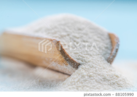 Collagen powder in spoon on wooden blue background. Collagen powder in spoon on wooden blue background. 88105990