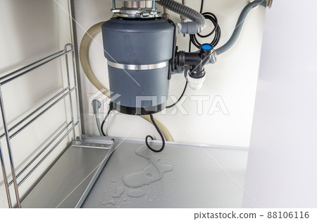 Waste disposal leak under a sink, broken garbage chopper Waste disposal leak under a sink, broken garbage chopper 88106116