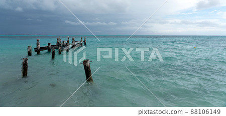 Remains of an old pier on Playa Caracol beach in Cancun, Mexico 88106149