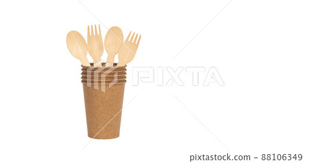 Eco brown cup and wooden fork, spoon on a white background. Mockup for your and copy space Eco brown cup and wooden fork, spoon on a white background. Mockup for your and copy space 88106349