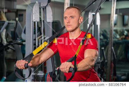Handsome man working out in fitness gym 88106764