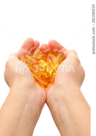 hands holding omega-3 fish fat oil capsules 88106910