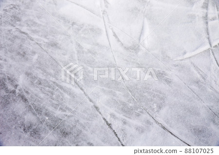 Ice background with marks from skating and hockey, blue texture of rink surface with many scratches Ice background with marks from skating and hockey, blue texture of rink surface with many scratches 88107025