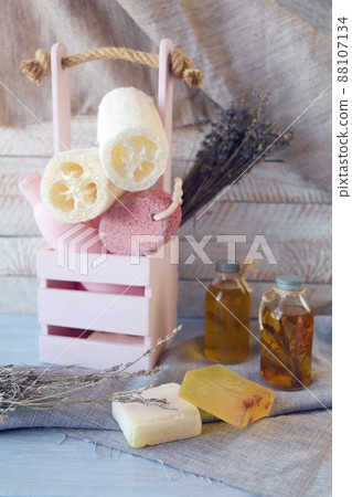 Hygiene products for body care and cleanliness, healthy oils and tinctures, a bouquet of lavender flowers in a box, on a wooden background, spa, natural ingredients 88107134