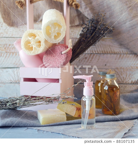 Hygiene products for body care and cleanliness, healthy oils and tinctures, a bouquet of lavender flowers in a box, on a wooden background, spa, natural ingredients 88107135