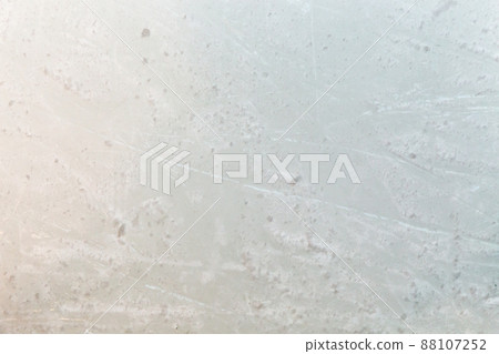Ice background with marks from skating and hockey, blue texture of rink surface with many scratches 88107252